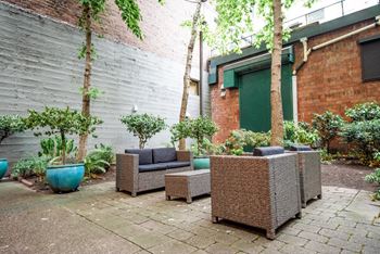 The courtyard has a seating area with furniture and plants
